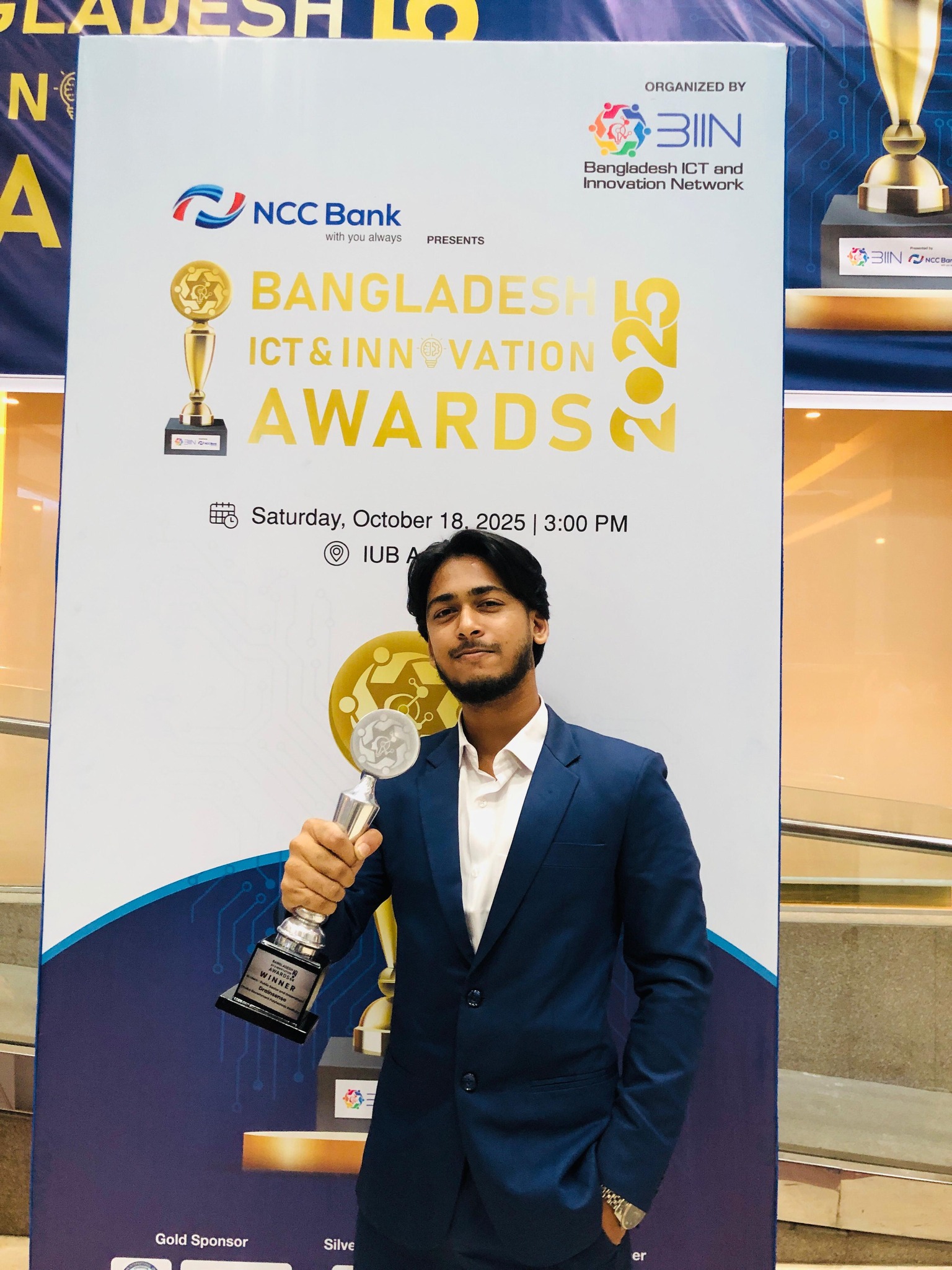 Rifat Ahmmed holding the ICT Innovation Awards 2025 Trophy